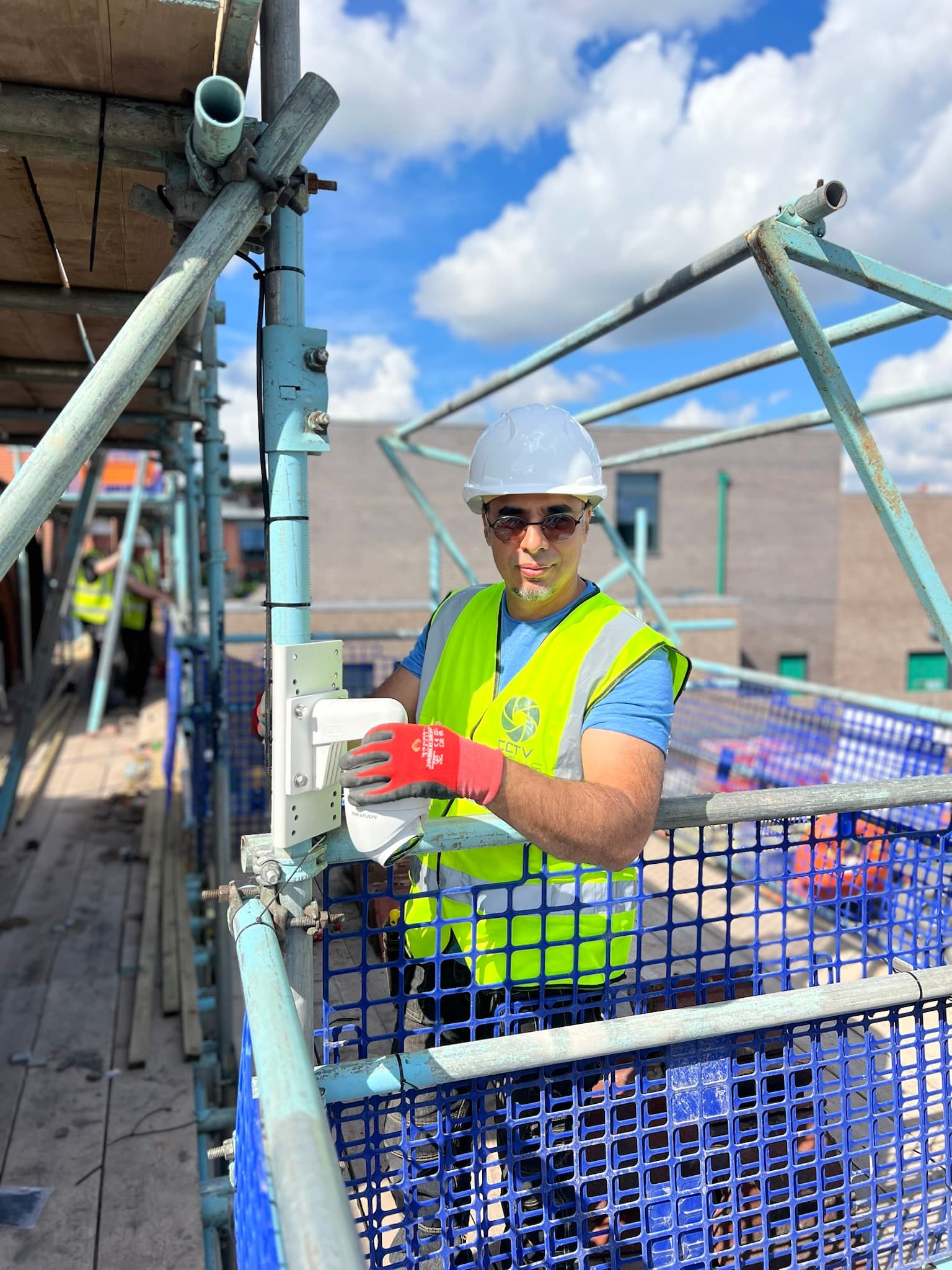 CCTV Focus engineer installing a camera on scaffolding at a school construction site